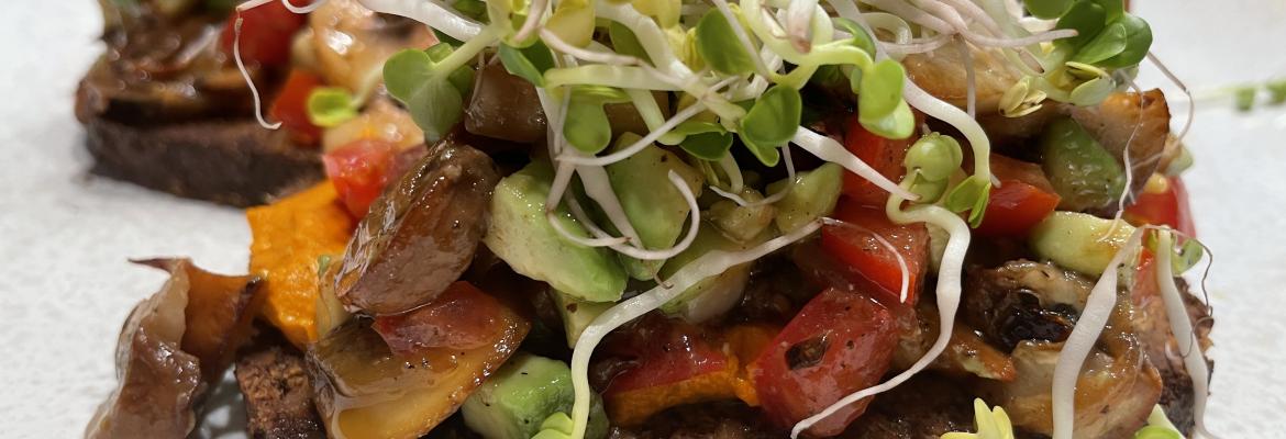 Lukewarm avocado tomato mushroom salad on bread